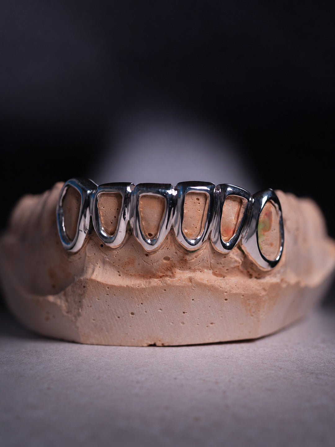 Silver teeth grillz across the bottom six, open face window style in sterling silver on mould