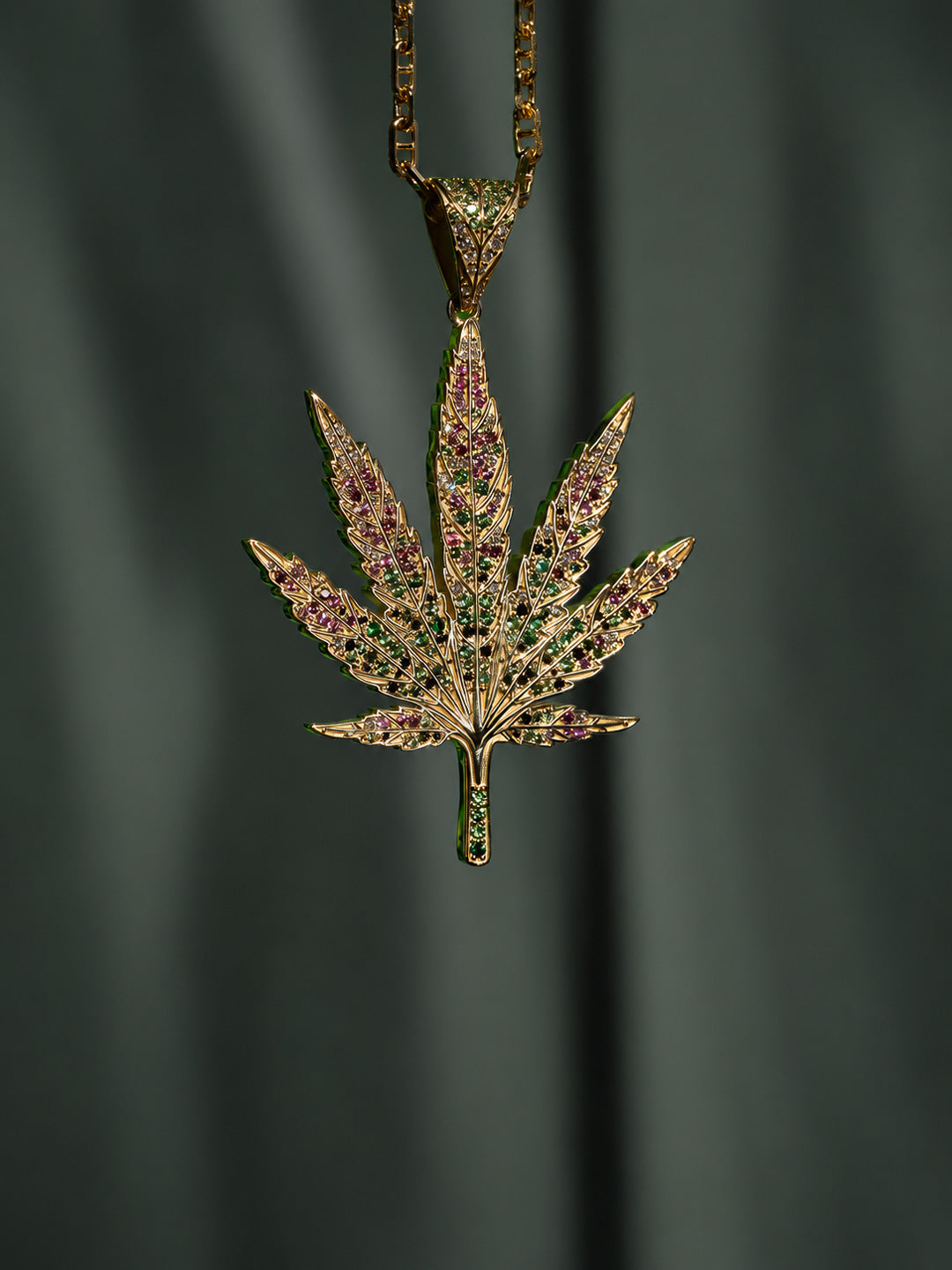 Custom cannabis leaf pendant in gold with sapphires, tsavorite and emerald, bespoke by Illoom Sydney