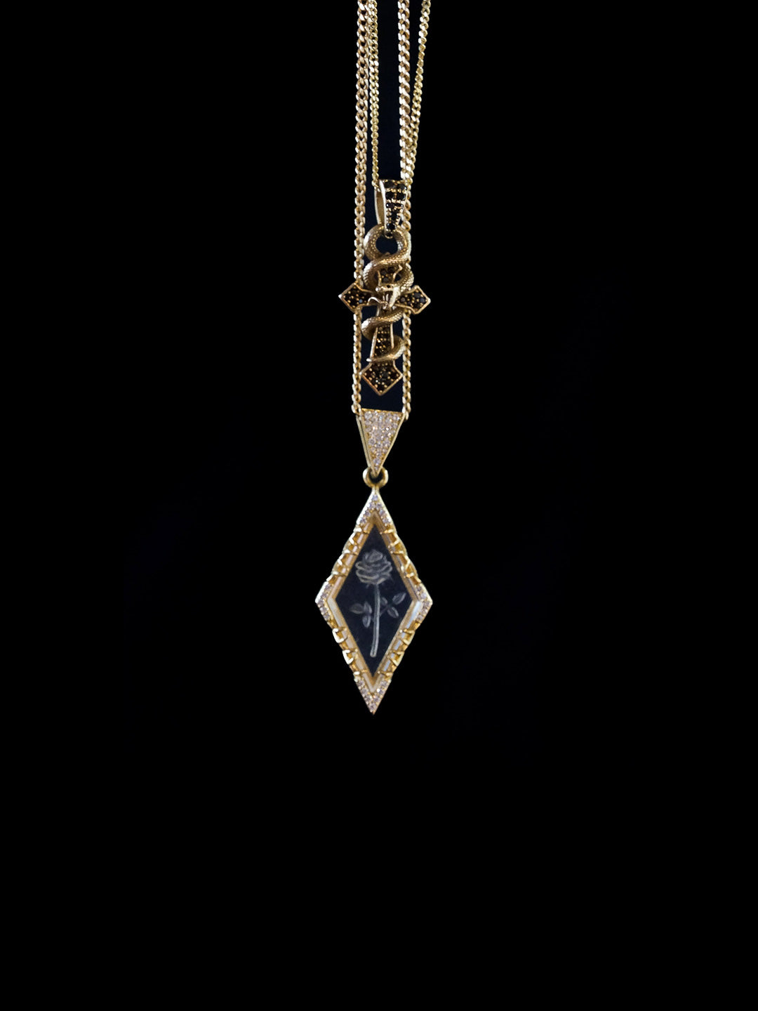Custom cross pendant with snake and glass-engraved intaglio pendant in gold with black and white diamonds, bespoke by Illoom Sydney