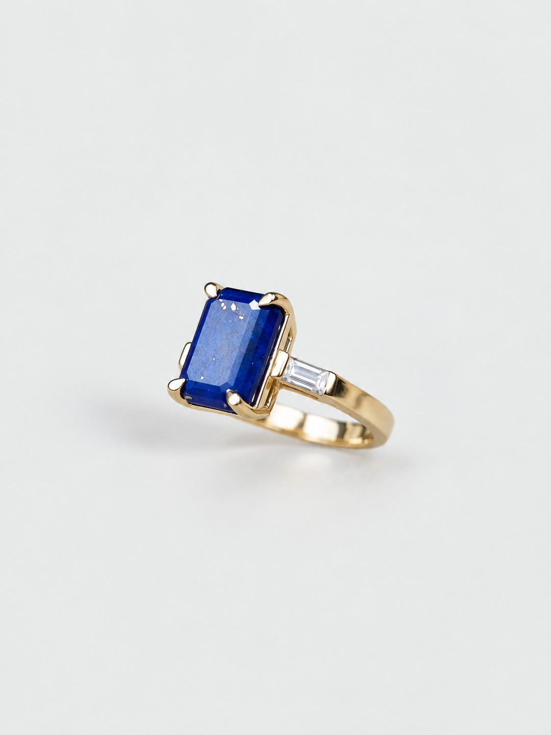Custom engagement ring in yellow gold with lapis lazuli centre and baguette diamond side stones, bespoke by Illoom Sydney