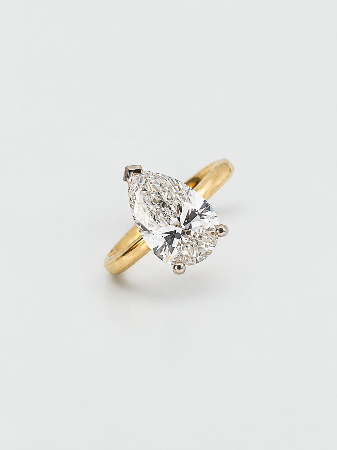 Custom engagement ring in yellow gold with pear cut diamond solitaire, bespoke by Illoom Sydney