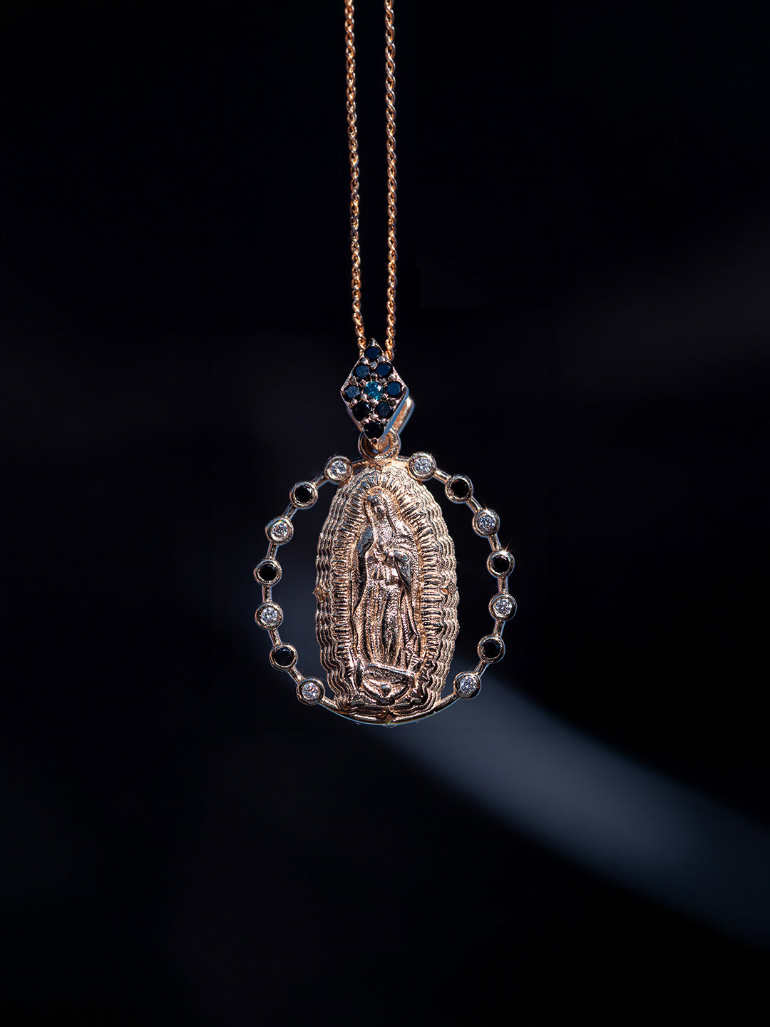 Custom Mother Mary religious pendant in yellow gold with black, white and blue diamonds, bespoke by Illoom Sydney