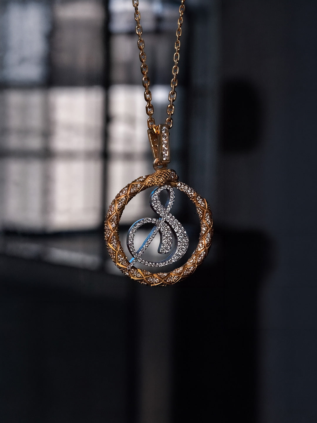 Custom ouroboros snake pendant in 18k yellow and white gold with pavé diamonds, bespoke by Illoom Sydney