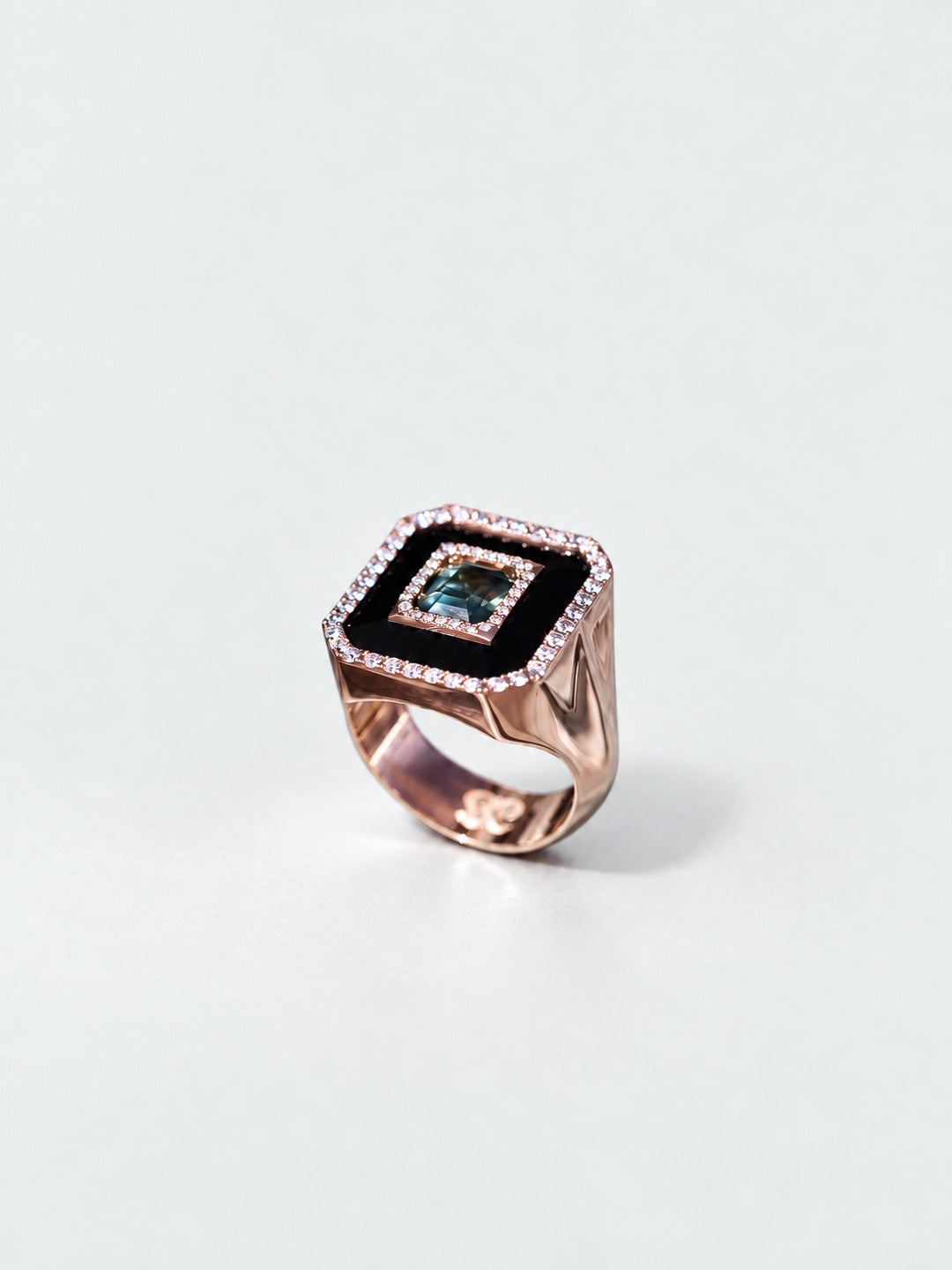 Custom signet ring in rose gold with onyx face, centre sapphire and pavé diamond border, bespoke by Illoom Sydney