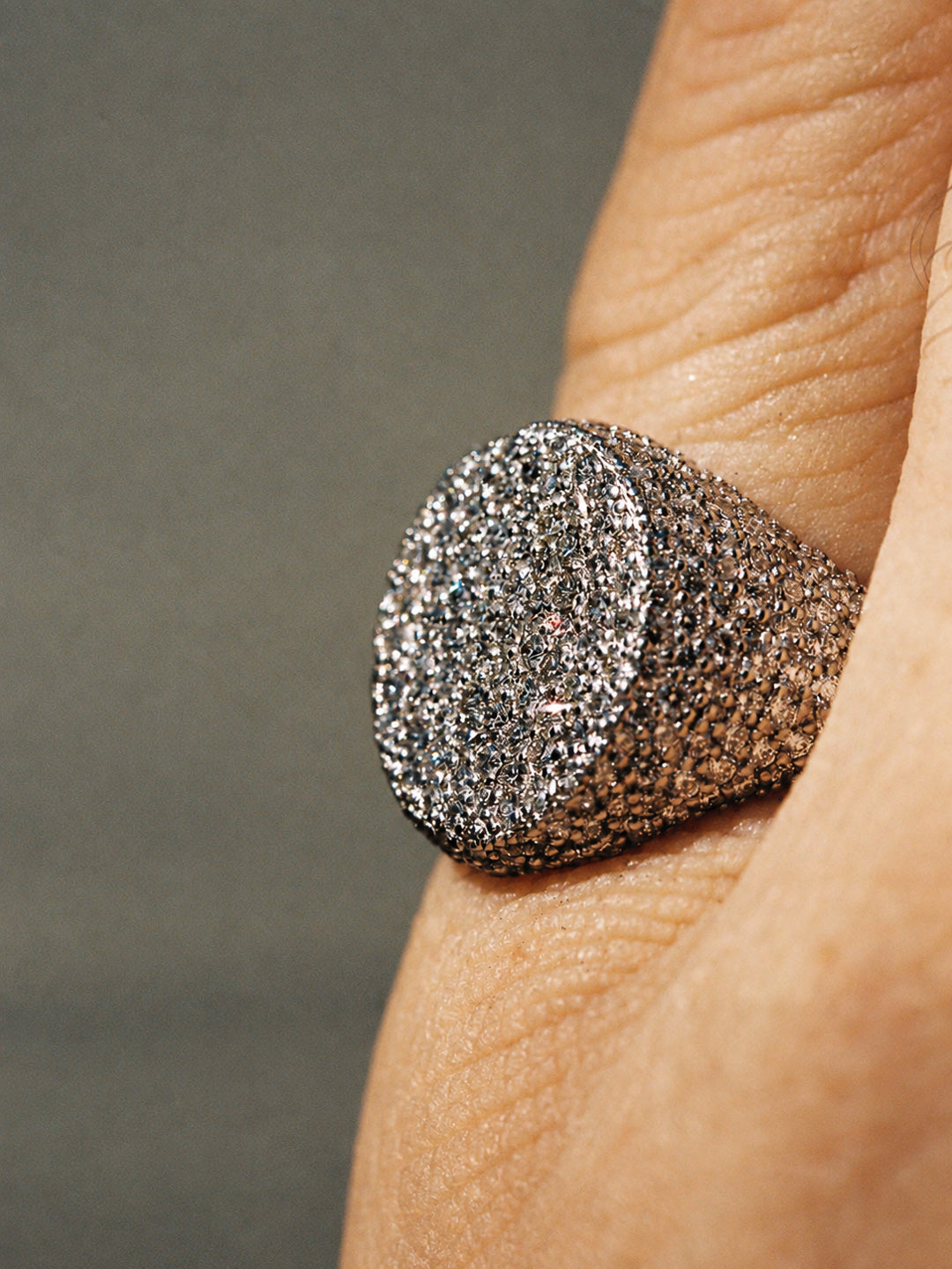 Custom round pavé diamond signet ring in white gold worn on hand, by Illoom Sydney