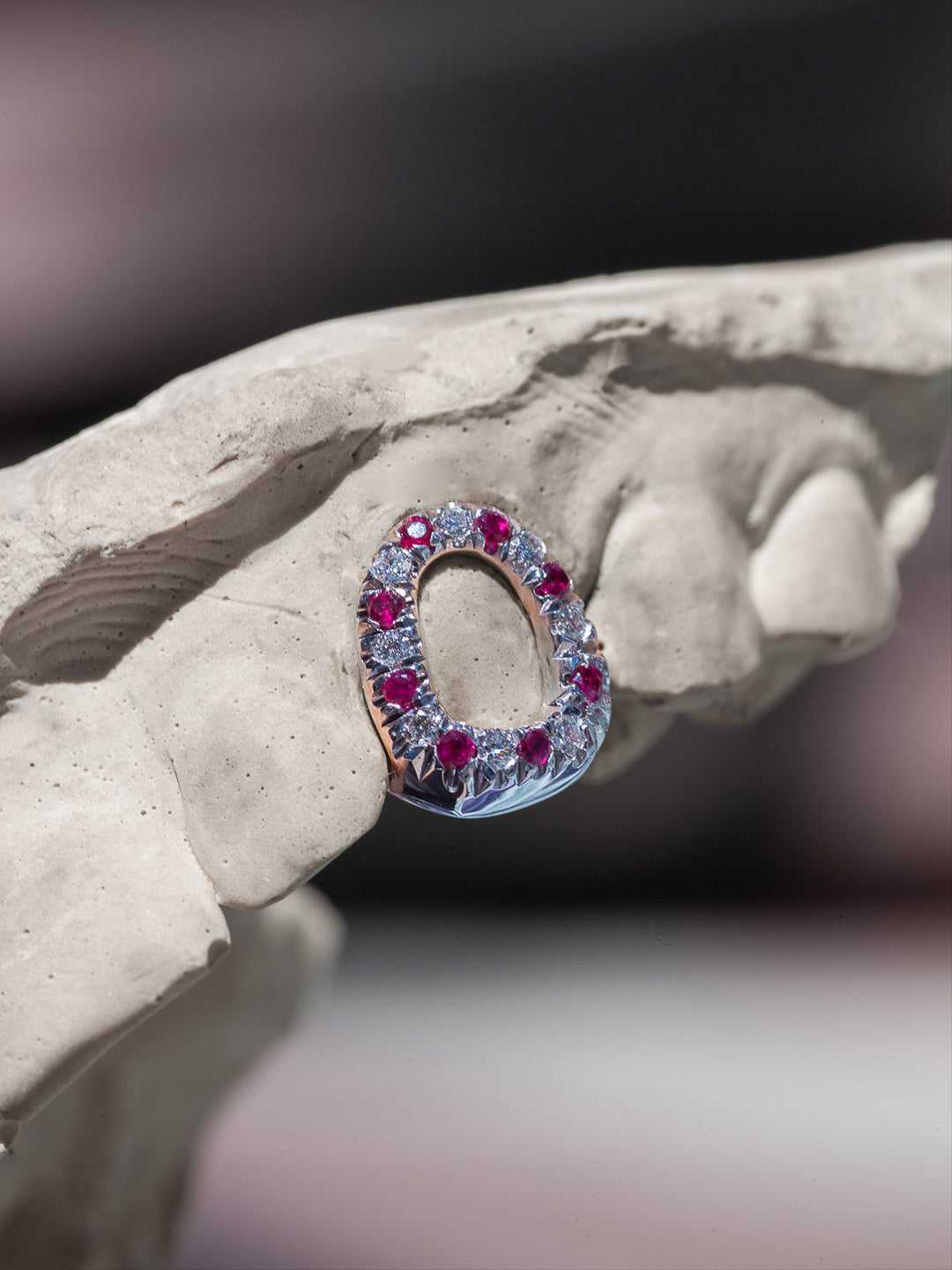 Ruby window grillz in silver with a pavé ruby border, open face style on dental mould, bespoke by Illoom Sydney